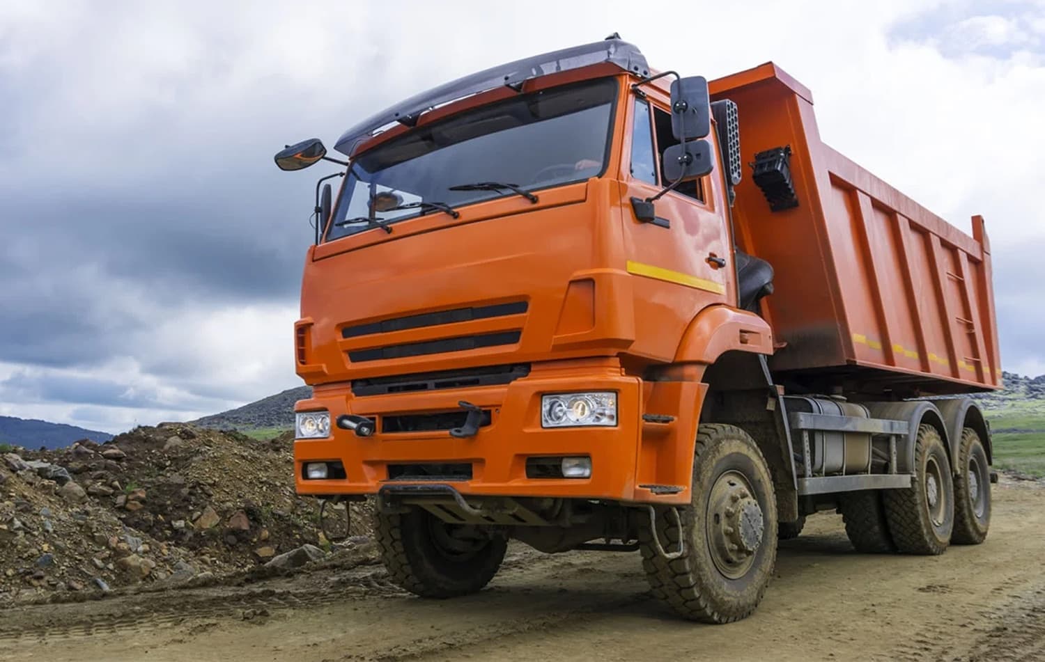 Orange dump truck on a construction site